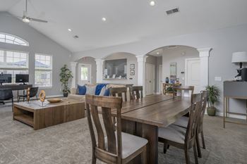 A dining room with a wooden table and chairs.